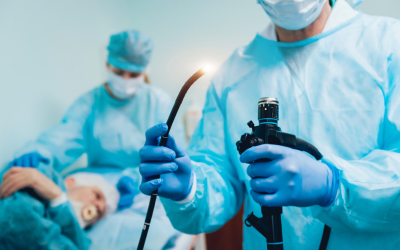 Â___endoscopic ultrasound eus | dr. Vipulroy rathod | dr. Vipulroy rathod Surgeons in blue scrubs and masks perform surgery; foreground surgeon holds a flexible endoscope while the patient lies on the table.