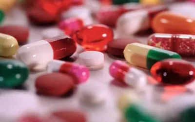Use of nsaids or antibiotics frequently | dr. Vipulroy rathod | dr. Vipulroy rathod Assorted capsules and tablets in various colors scattered across a surface.